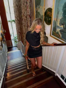 Detail shot of the elegant two-piece outfit featuring lace trim and a slim-fit miniskirt.