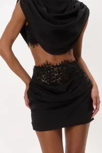 Detailed view of a chic black two-piece set with a draped top and lace corset skirt.