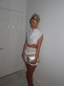 Elegant white two-piece crop top and lace corset skirt set, perfect for stylish evening wear.