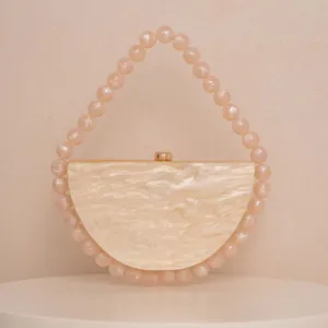 Elegant semicircular acrylic evening clutch with pearlescent beaded handle, chic champagne chic.