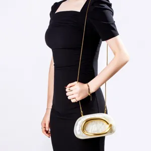 Elegant white marble acrylic evening clutch bag featuring a gold chain strap and metal clasp.