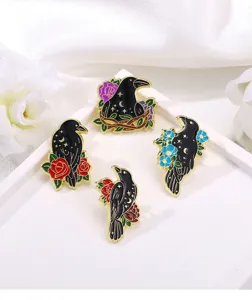Close-up detail of dark style enamel crow brooch featuring starry sky and colorful flower motifs.
