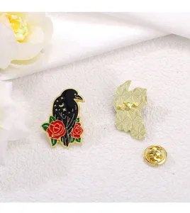 Detailed view of the gothic black crow enamel pin featuring red roses and starry night design.