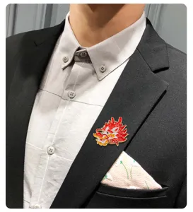 Detailed shot of a Chinese style red dragon enamel brooch, elegant alloy lapel pin accessory.