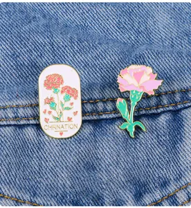 Close-up detail of cute carnation enamel pins set on denim, alloy backpack clothing badge.