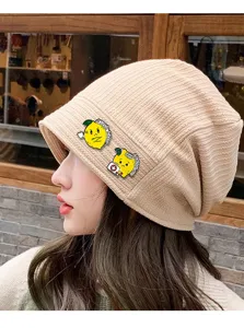 Detail shot of cute lemon enamel brooch pin, cartoon fruit alloy badge for clothes and backpack.