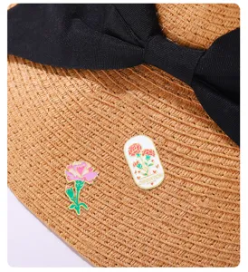 Close-up detail of carnation enamel pins set, alloy floral brooch for clothing decoration.