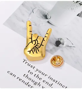Gold rock hand sign brooch lapel pin alloy metal clothing decoration fashion badge accessory.