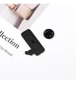 Detailed view of black metal enamel pin back, secure clutch attachment, sturdy alloy.