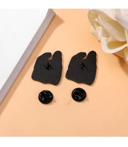 Detailed view showing the back structure of a black alloy cartoon plastic bag enamel brooch pin.