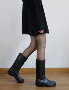 Close-up of fleece lined fake sheer black tights with cute heart patterns paired with boots.