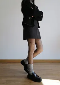 Detailed view of women thermal fleece lined fake translucent black tights with cute heart patterns.