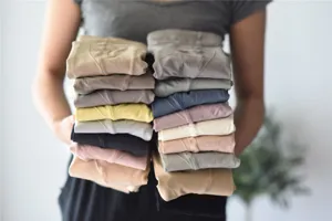 Detail shot showcasing stacked colorful ribbed tights in multiple Morandi shades for autumn winter.