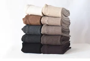 Thick fleece-lined leggings stacked neatly, showing warm vertical stripe winter fabrics.
