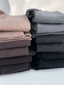 Fleece-lined thermal stirrup leggings detail, thick winter warm footed pants, neutral colors.