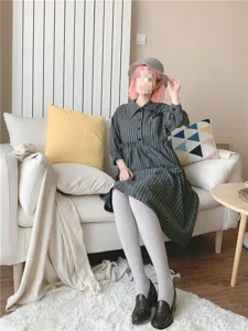 Detailed view of women's ribbed thick thermal pantyhose styled with a cozy striped dress.
