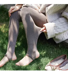 Close-up detail of ribbed fleece-lined stirrup leggings showing texture and stretch.