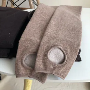 Thickened fleece-lined stirrup leggings detail view showing warm winter fabric and foot design