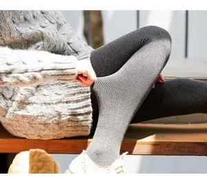 Winter fleece-lined ribbed thermal leggings for women, warm thick stretch footed tights.