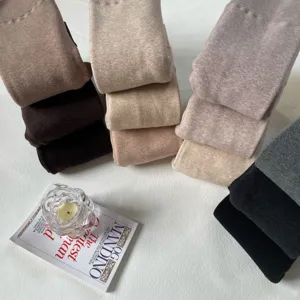 Detailed view of thick thermal fleece lined tights in neutral tones, soft fabric for winter.