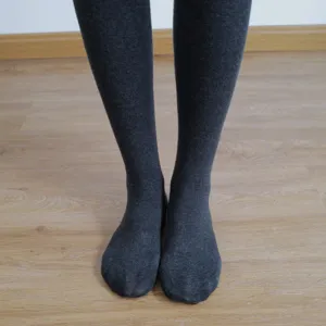Detailed view of women's thick fleece-lined grey tights showing soft stretchy fabric.