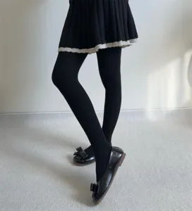 Detail view of black ribbed winter tights, soft warm wool blend pantyhose for women.