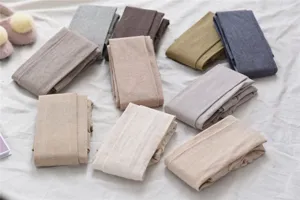 Detailed view of women soft fleece lined leggings in multiple neutral colors, soft knit texture.
