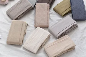Detailed view of soft cotton striped tights in various autumn neutral colors, fine knit.