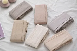 Detailed view of soft textured knit tights in cozy neutral oat and beige winter shades.