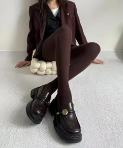 Brown herringbone knit tights for women, stylish thermal winter hosiery paired with chic loafers.