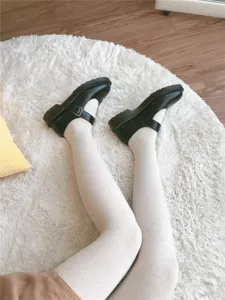 Comfortable oatmeal milk apricot vertical striped tights paired with vintage green shoes.