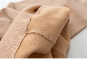Detailed close-up of thick winter thermal tights interior showing soft plush fleece texture.