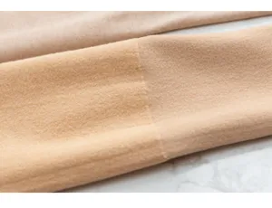 Close-up view of thick fleece-lined thermal tights fabric, showing soft texture and cozy warmth.