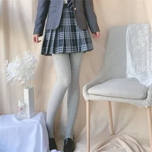 Grey knit tights detail shot showing soft texture and cozy autumn outfit pairing.