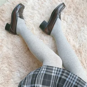 Cozy women's knit tights paired with retro brown loafers and plaid skirt for autumn and winter.