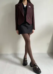 Textured knit tights in deep brown, featuring a chic water wave pattern for stylish autumn wear.