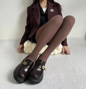Detail shot of brown herringbone knit tights for women, chic autumn winter thermal hosiery.