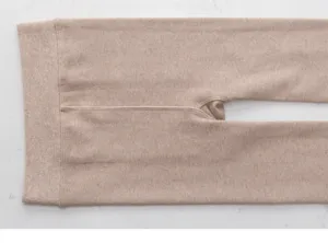 Detail shot of womens winter thick ribbed tights in camel, soft thermal knitted hosiery item.
