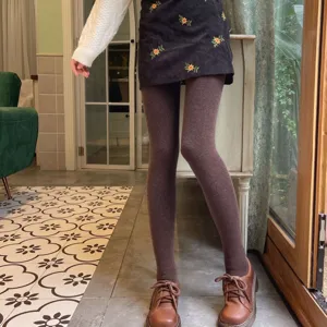 Thermal fleece-lined footed tights detail shot, cozy autumn winter apparel collocation style.
