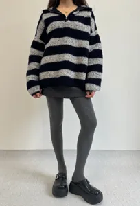 Grey thermal tights detail shot featuring cozy leggings paired with stylish fuzzy sweater.