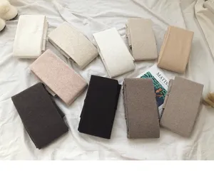 Detail shot of thick warm fleece winter tights folded neatly in various neutral colors for cold days.