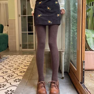 Detailed shot of fleece lined footed tights in coffee brown, featuring cozy winter style and fit.