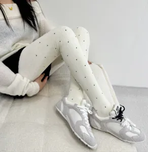 Detail view of thick winter fleece-lined polka dot tights with right-angle heel design.