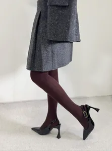 Detail shot of autumn winter women tights hosiery featuring retro dark pattern design close-up.
