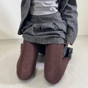 Detailed view of women's autumn winter tights pantyhose with cute heart jacquard pattern.
