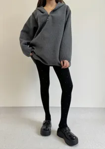 Detailed view of women polka dot jacquard tights paired with cozy fleece hoodie.
