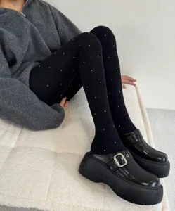 Thick fleece-lined winter tights with cute polka dot pattern, cozy thermal hosiery for women.