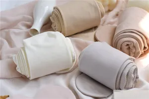 Detailed view of women winter slimming pantyhose in assorted pastel colors, soft textured fabric.