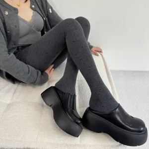 Grey fleece-lined dotted tights with thick warm fabric, perfect winter cozy hosiery detail.