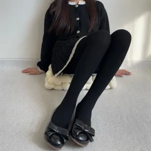 Black ribbed tights detail, winter warm thick hosiery, cozy home indoor scene view